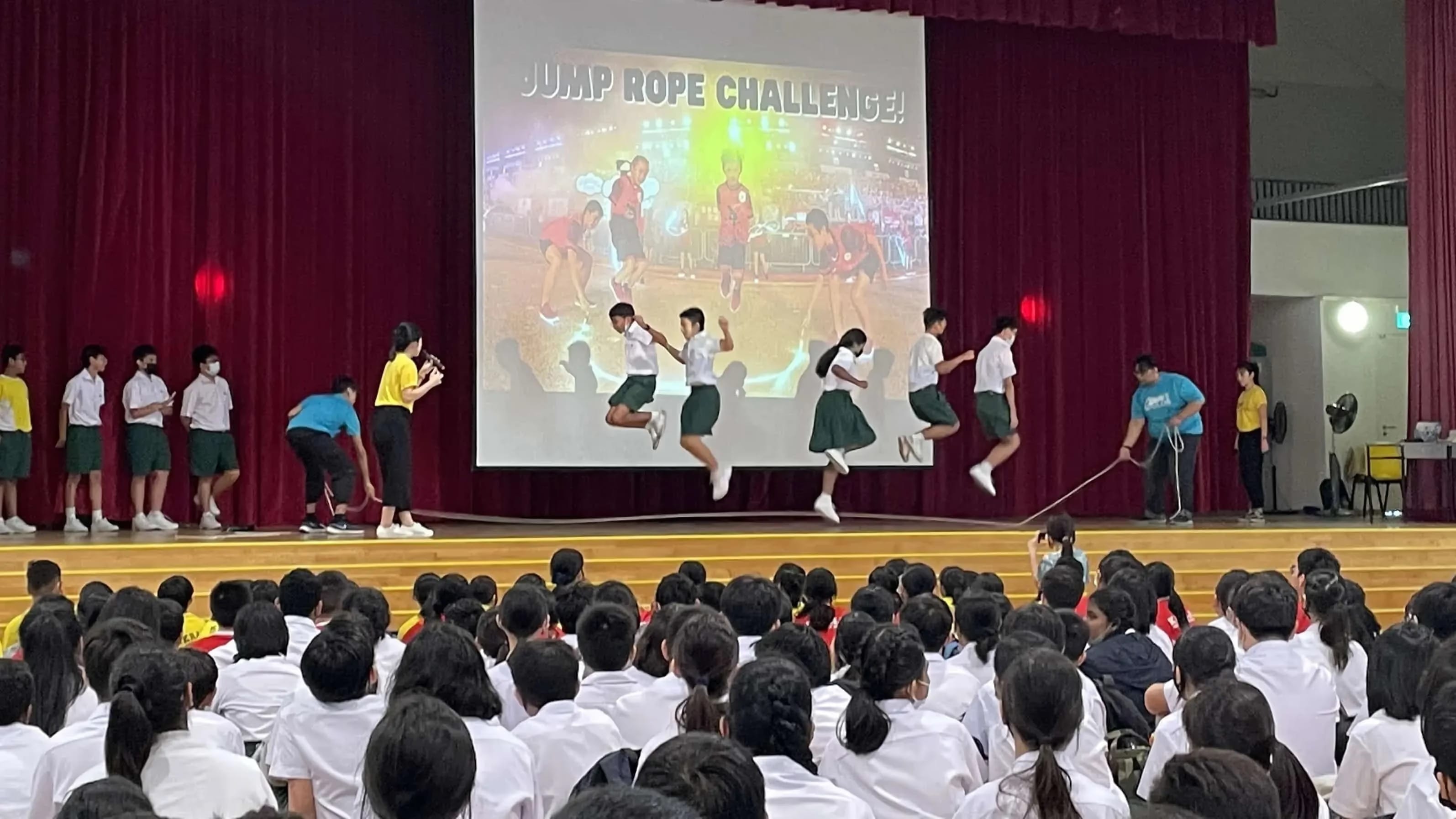 Students participating in the jump rope challenge during assembly.